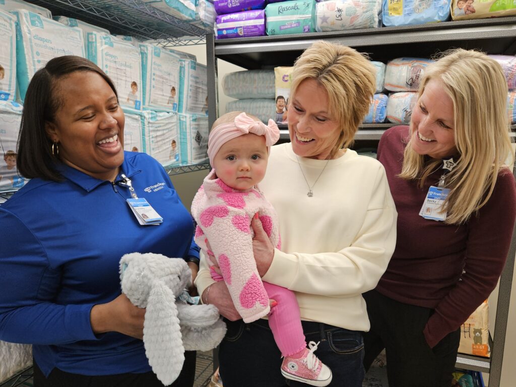 A’onesty Cross, left, and Becky Barker, right, of the Franciscan Supplementary Diaper Pantry, share a laugh with Pamela Anderson and her granddaughter, Jaayla Szutenbach, in the Crown Point pantry.