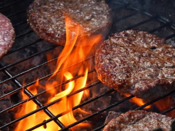 Hamburgers on a fiery grill