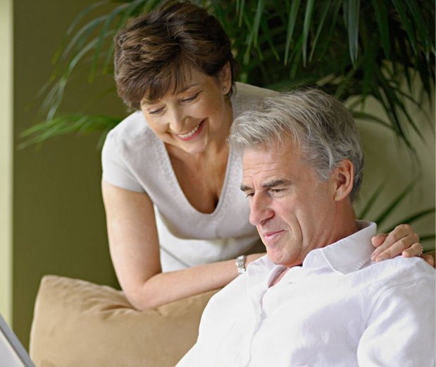 couple at retirement age review documents together