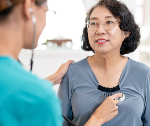 Nurse listening to the heart of a cardiac patient