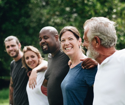 a line of people with their arms around each others shoulders