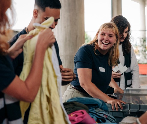 Volunteer group sorting through donated clothes