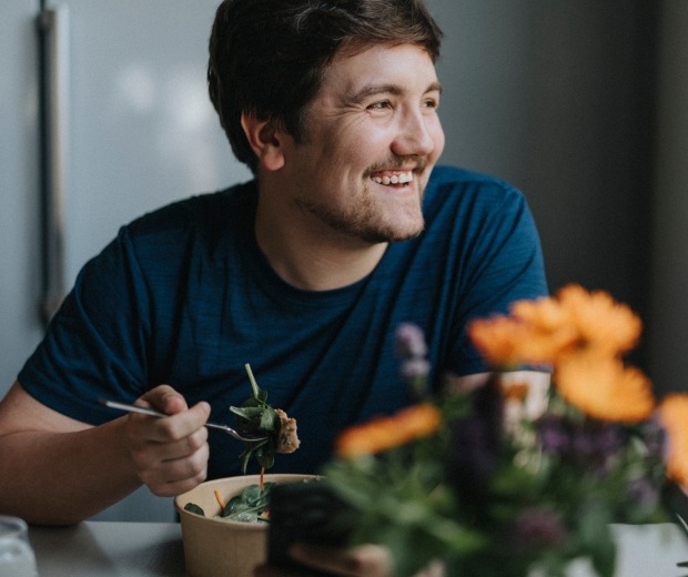 A man smiling out the window