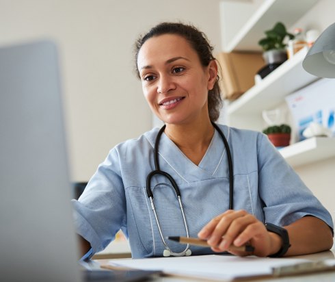 nurse looking at a computer screen