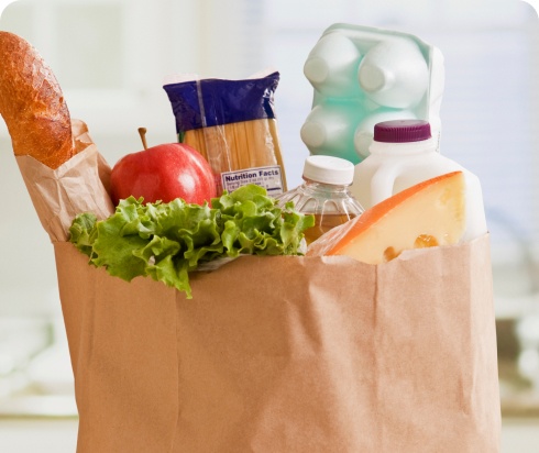 Paper grocery bag overflowing with fresh food