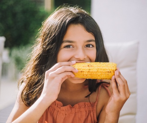 Girl eating corn on the cob