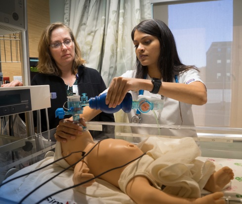Nurses in training center with nursing mannequin