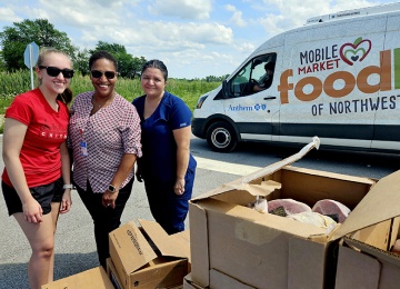 women packing the mobile market van