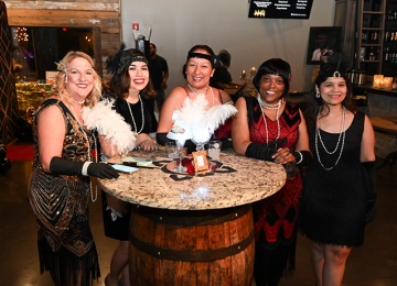 Women dressed in roaring 20s costumes at event