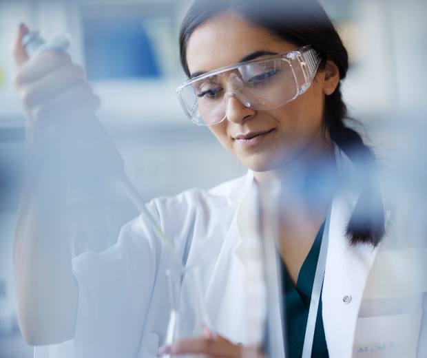 Researcher using tools in a lab