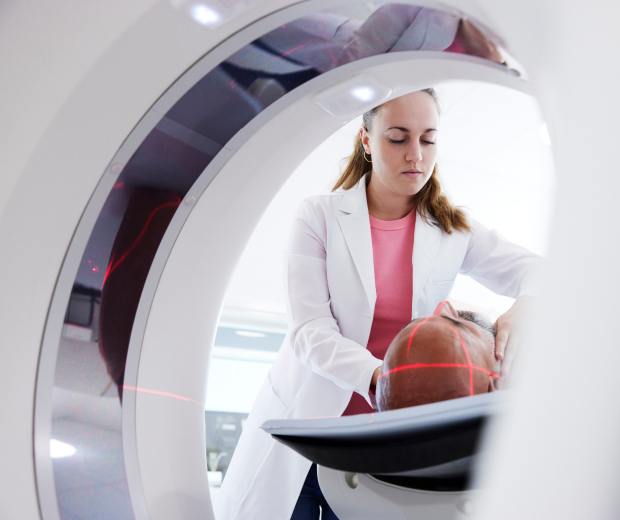 Radiologist performing scan on patient