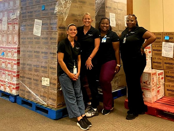 some of the nearly 250,000 diapers recently donated to Franciscan Health’s Prenatal Assistance Program are (l-r) Franciscan Community Health Prenatal Coordinator Jodi Perrine, Franciscan Diaper Pantry Community Health Specialist Becky Barker, Franciscan Community Health Prenatal Care Coordinator A’onesty Cross and Franciscan Community Health Prenatal Care Manager Doucette Alvarez.