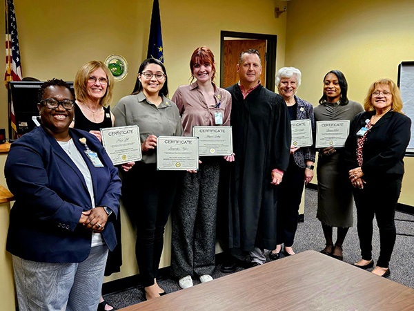 Pictured are (l-r) VASIA Director LaVonne Jarrett, Karen Hill, Jaquelyn Mojica, Abigail Gidley, Lake Superior Court Probate Commissioner Ben Ballou, Barbara Cerwinske, Quiana Scott and VASIA Volunteer Coordinator Francisca Mendoza