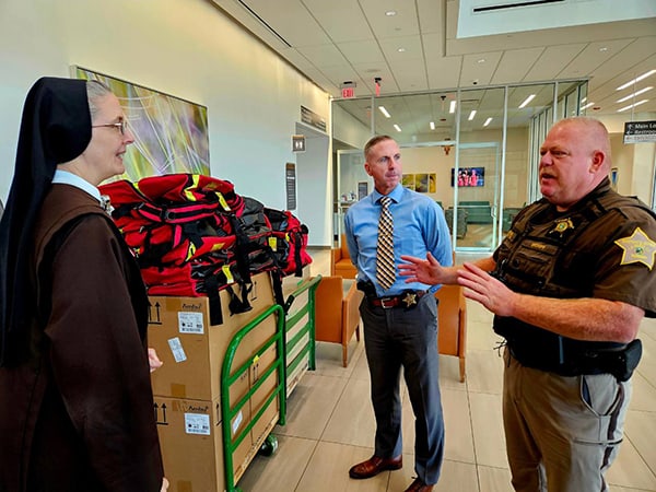 Franciscan Health Michigan City President and CEO Dean Mazzoni, LaPorte County Sheriff’s Office Administrative Capt. Derek Allen, LaPorte County Sheriff’s Office Captain Dallas Smythe and Vice President of Mission Integration for Franciscan Health’s Northern Indiana Division Sister M. Petra Nielsen display emergency equipment backpacks donated by the hospital to the Sheriff’s Office.