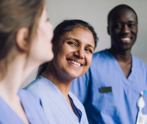 team of nurses smiling at each other