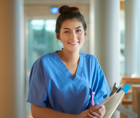 Smiling nurse holding clipboard