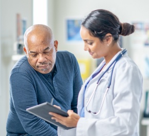 doctor reviews results on clipboard with patient