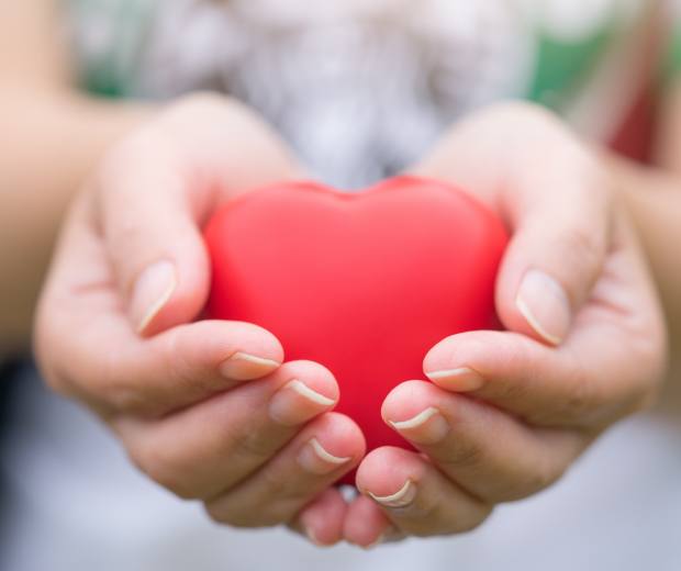 hand holding heart-shaped object