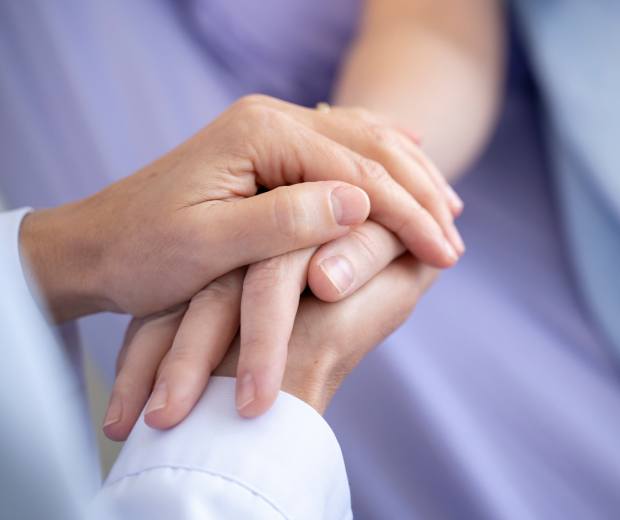 doctor holding patient's hand