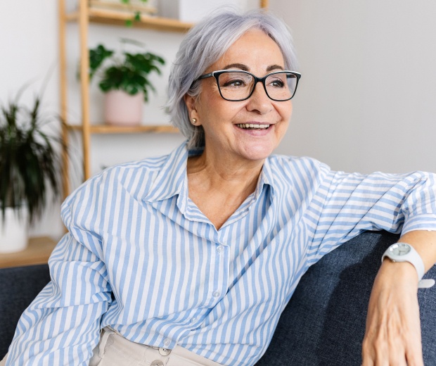 elderly professional woman smiling on a couch