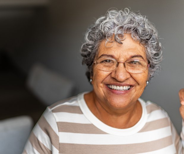 Elderly woman smiling at doorway