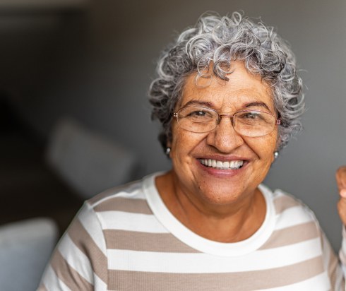 Elderly woman smiling at doorway