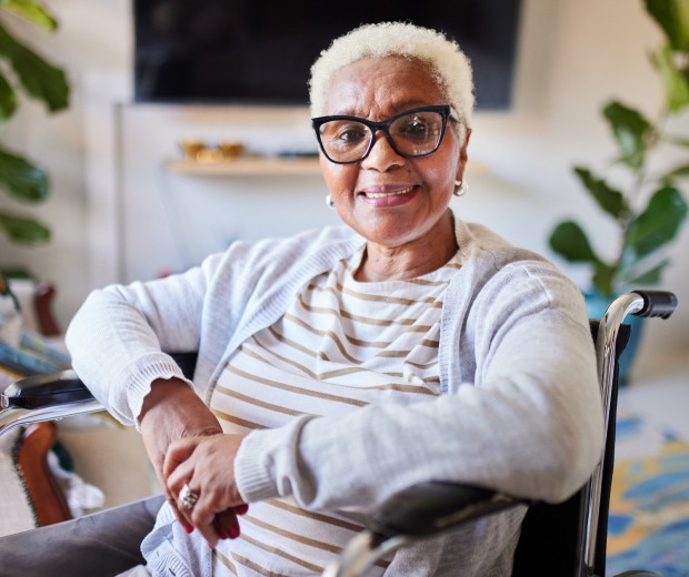 Elderly woman smiling in a wheelchair