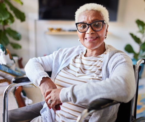 Elderly woman smiling in a wheelchair